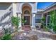 Front entry with arched columns and a brown door at 7823 33Rd E St # 20, Sarasota, FL 34243