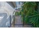 Backyard access with a black metal gate and landscaping at 7823 33Rd E St # 20, Sarasota, FL 34243