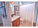 Guest bathroom with tub shower combo and wood vanity at 7823 33Rd E St # 20, Sarasota, FL 34243