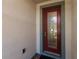 Inviting front door with glass accents and a red finish at 3711 76Th E St, Palmetto, FL 34221