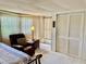 Bedroom with recliner and double doors to outside at 1806 Brook Field Ter, Sarasota, FL 34234