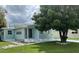 Light blue manufactured home with landscaped yard at 1806 Brook Field Ter, Sarasota, FL 34234