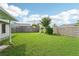 Backyard with green grass, wooden fence and garden arch at 8124 Glenbrooke Pl, Sarasota, FL 34243