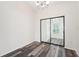 Simple dining room with wood-look flooring and mirrored sliding door at 8124 Glenbrooke Pl, Sarasota, FL 34243