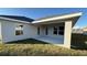 Covered back patio extends from the house with access from two doors at 2620 Averland Loop, North Port, FL 34287
