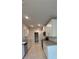 Modern kitchen with white cabinets, granite counters, and stainless steel appliances at 2620 Averland Loop, North Port, FL 34287