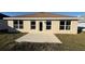 Newly built home with small patio and grassy backyard at 2624 Averland Loop, North Port, FL 34287