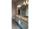 Double vanity bathroom with granite countertop at 2624 Averland Loop, North Port, FL 34287