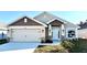 Two-story home with a neutral color palette and landscaped yard at 2624 Averland Loop, North Port, FL 34287