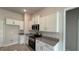 Modern kitchen with white cabinets, granite counters, and stainless steel appliances at 2624 Averland Loop, North Port, FL 34287