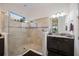 Large bathroom with a walk-in shower, granite countertop, and dark vanity at 5585 Semolino St, Nokomis, FL 34275