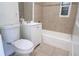 Simple bathroom with a toilet, bathtub, and white vanity at 2708 Starlite Ln, Port Charlotte, FL 33952