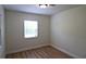 Simple bedroom with light walls, a window, and laminate wood flooring at 2708 Starlite Ln, Port Charlotte, FL 33952