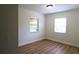 Bright bedroom with new flooring and two windows at 2708 Starlite Ln, Port Charlotte, FL 33952