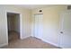 Well-lit bedroom with tile floors, double-door closet and access to another room at 2708 Starlite Ln, Port Charlotte, FL 33952