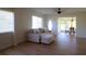 Living room with light beige sectional sofa and wood floors at 2708 Starlite Ln, Port Charlotte, FL 33952