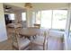 Bright dining area with a round table and four chairs, looking into living room at 2708 Starlite Ln, Port Charlotte, FL 33952