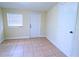 Bright bedroom with tile floors, exterior access, and window with blinds at 2708 Starlite Ln, Port Charlotte, FL 33952
