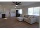 Living room with light beige sectional sofa and kitchen view at 2708 Starlite Ln, Port Charlotte, FL 33952