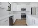 Modern kitchen showcasing stainless steel appliances and white cabinetry at 14390 Maddock Ave, Port Charlotte, FL 33953