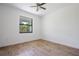 Bright bedroom with wood floors and ceiling fan at 14390 Maddock Ave, Port Charlotte, FL 33953
