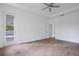 Spacious bedroom with light hardwood floors and access to a private patio at 14390 Maddock Ave, Port Charlotte, FL 33953
