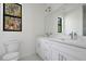 Contemporary bathroom with double vanity and large mirror at 14390 Maddock Ave, Port Charlotte, FL 33953