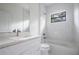 Modern bathroom with white vanity, marble shower/tub combo, and large mirror at 14390 Maddock Ave, Port Charlotte, FL 33953