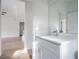 Bright bathroom with white vanity and a view into a spacious living area at 14390 Maddock Ave, Port Charlotte, FL 33953