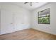 Light bedroom with wood floors and large window at 14390 Maddock Ave, Port Charlotte, FL 33953