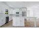 White kitchen with stainless steel appliances and an expansive island at 14390 Maddock Ave, Port Charlotte, FL 33953