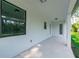 Covered patio with multiple windows overlooking a grassy backyard at 14390 Maddock Ave, Port Charlotte, FL 33953