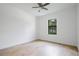 Bright bedroom featuring hardwood floors and a large window with wooded views at 14390 Maddock Ave, Port Charlotte, FL 33953