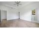 Bright bedroom featuring hardwood floors and an ensuite bathroom at 14390 Maddock Ave, Port Charlotte, FL 33953