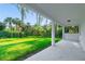 Covered patio overlooking a lush green backyard with tropical landscaping at 14390 Maddock Ave, Port Charlotte, FL 33953