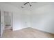 Well-lit bedroom with hardwood floors, ceiling fan and access to hallway at 14390 Maddock Ave, Port Charlotte, FL 33953