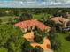 Luxury home with tile roof and circular driveway, aerial view at 909 Macewen Dr, Osprey, FL 34229