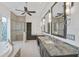 Elegant bathroom with dual vanities, a soaking tub, and a walk-in shower at 909 Macewen Dr, Osprey, FL 34229