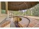 Covered outdoor kitchen with brick bar and sink at 909 Macewen Dr, Osprey, FL 34229