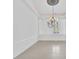 Bright dining room with elegant chandelier and tile floors at 909 Macewen Dr, Osprey, FL 34229