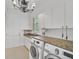 Laundry room with granite countertops, white cabinets, and Samsung washer/dryer at 909 Macewen Dr, Osprey, FL 34229