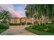 Mediterranean style home with palm trees and circular driveway at 909 Macewen Dr, Osprey, FL 34229