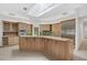 Large kitchen with island, wood cabinets, and stainless steel appliances at 909 Macewen Dr, Osprey, FL 34229
