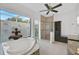 Spa-like bathroom with soaking tub, walk-in shower, and private courtyard view at 909 Macewen Dr, Osprey, FL 34229