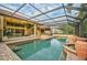 Resort-style pool with covered patio, brick pavers, and large urns at 909 Macewen Dr, Osprey, FL 34229