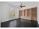 Home office featuring built-in bookshelves and dark hardwood floors at 909 Macewen Dr, Osprey, FL 34229