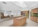 Open kitchen with island and Gathering room access at 909 Macewen Dr, Osprey, FL 34229