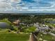 Aerial view of a country club and golf course at 909 Macewen Dr, Osprey, FL 34229