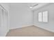 Bright bedroom with neutral carpet, white walls, and plantation shutters at 909 Macewen Dr, Osprey, FL 34229