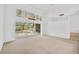 Spacious living room with sliding glass doors leading to the pool at 909 Macewen Dr, Osprey, FL 34229